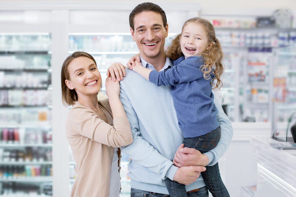 Cheerful glad family posing in drugstore